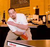 The author playing table tennis at a charity event
